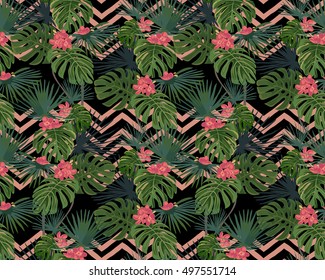 Exotic tropical leaves and flowers on a black background. Vector seamless pattern.