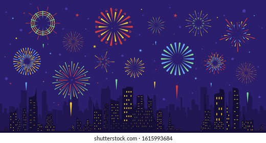 Exploding colorful fireworks display on night sky over cityscape, buildings. Stars,skyline and salute.