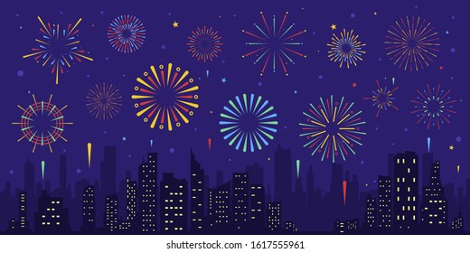 Exploding colorful fireworks display on night sky over cityscape, buildings. Stars,skyline and salute.