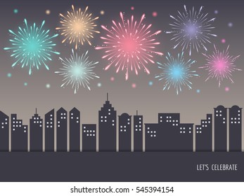 Exploding colorful fireworks display on night sky over cityscape, buildings. Fireworks for carnival, celebration, anniversary, new year and holiday party background.