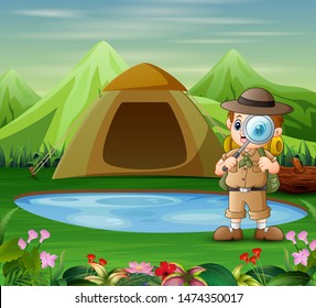 The explorer boy with a magnifying glass in nature