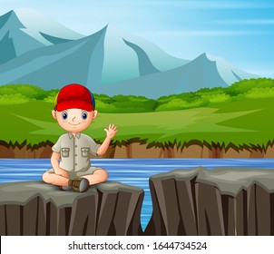 The explorer boy sitting on the cliff