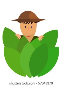 An explorer hidden behind jungle leaves