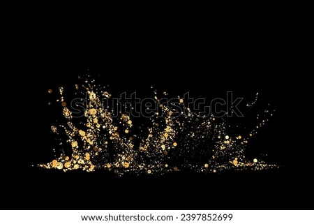 Explosion of golden particles on a dark background. Holiday background or design element