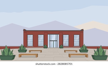 Exterior view of modern red brick office building with courtyard benches and potted plants