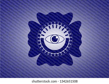 eye icon inside badge with denim background