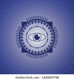 eye icon inside emblem with jean background