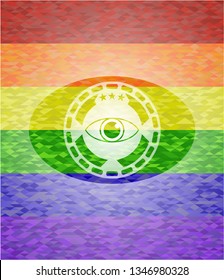 eye icon inside emblem on mosaic background with the colors of the LGBT flag
