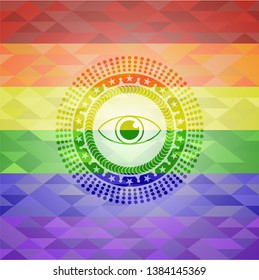 eye icon inside emblem on mosaic background with the colors of the LGBT flag