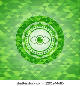 eye icon inside green mosaic emblem