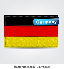 Fabric texture of the flag of Germany with a blue bow.