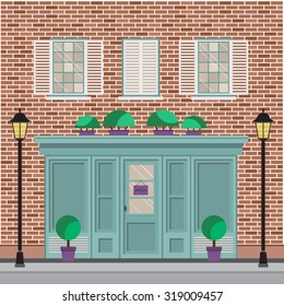Facade of the building with shop or cafe on the ground floor. 