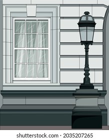 The facade of the building with a window and a street lamp in the classicism style.