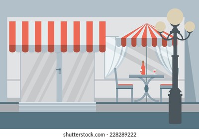 The facade of the cafe with umbrellas, chairs, tables
