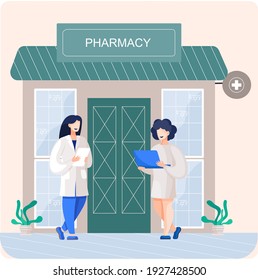 Facade pharmacy store with signboard, awning and symbol in shop window. Pharmacists women at entrance. Shop for sale of medicines and medical supplies. Pharmaceutical laboratory building front view