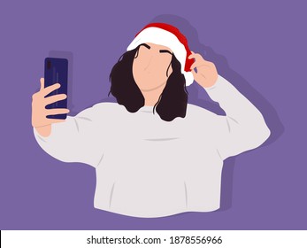 Faceless portrait of a young beautiful girl with dark curly hair taking selfie in a Christmas Santa hat