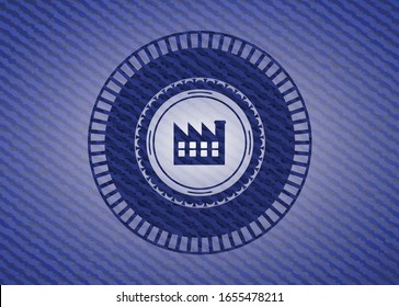 factory icon inside badge with denim background