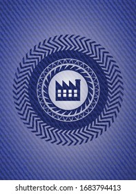 factory icon inside badge with denim background