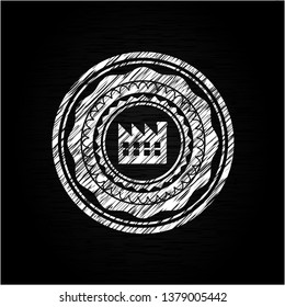 factory icon inside chalk emblem written on a blackboard