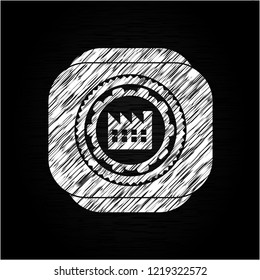 factory icon inside chalkboard emblem written on a blackboard