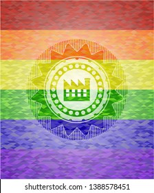 factory icon inside emblem on mosaic background with the colors of the LGBT flag