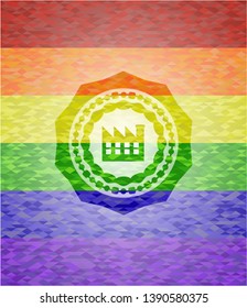 factory icon inside emblem on mosaic background with the colors of the LGBT flag