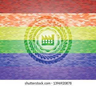 factory icon inside emblem on mosaic background with the colors of the LGBT flag