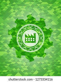 factory icon inside green emblem with mosaic ecological style background