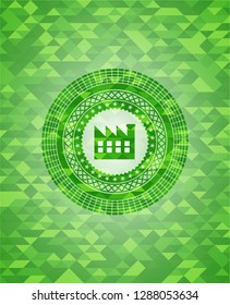 factory icon inside green emblem. Mosaic background