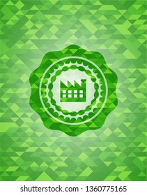 factory icon inside green emblem with mosaic ecological style background