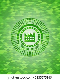factory icon inside green emblem with mosaic ecological style background. 