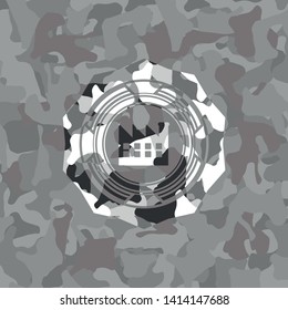 factory icon inside grey camouflaged emblem