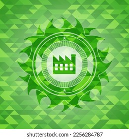 factory icon inside realistic green mosaic emblem. 