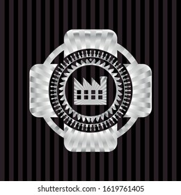 factory icon inside silvery emblem or badge