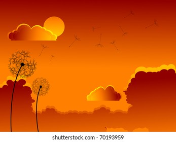 Faded dandelion over sunset sky
