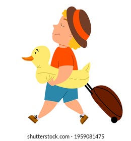 A fair-haired cute boy comes with a suitcase and a duck swimming circle.