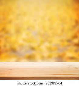 Fall blurred background with wooden table for your design. Vector illustration.
