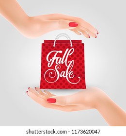 Fall sale lettering on shopping bag between two hands. Autumn offer or sale advertising design. Handwritten text, calligraphy. For leaflets, brochures, invitations, posters or banners.