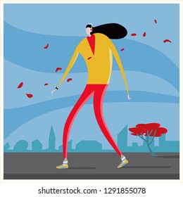 Fallen leaves, woman with heaphones walking in the street Geek musical woman walking on road at city, Autumn, falling leaves, Athletic build, headphones, smart watches, black hair develops the wind