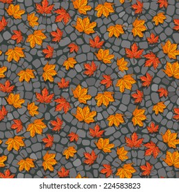 Fallen maple leaves lying on the stone pavement. Vector seamless pattern.