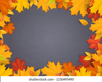 Fallen maple leaves on black chalkboard background. Welcome back to school background with space for advertising text.