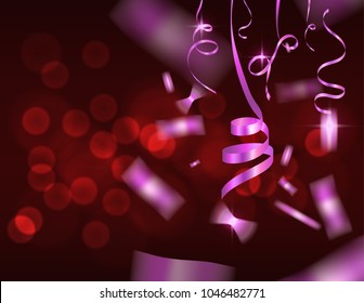 falling pink confetti on abstract red blurred background 
