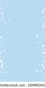 Falling snowflakes christmas background. Subtle flying snow flakes and stars on light blue winter backdrop. Beautifully falling snowflakes overlay. Vertical vector illustration.