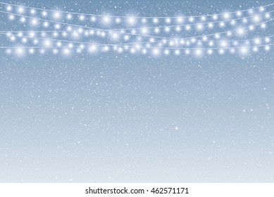 Falling white snow with blue winter sky and glowing garland. Merry Christmas and New Year background, banner, poster, card. Holiday backdrop style with fall shining snow and slight bulb.