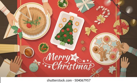 Family celebrating Christmas at home and eating together, table top view, flat lay