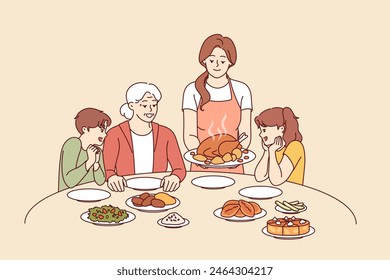 Family celebration of thanksgiving with joint dinner and delicious turkey cooked according to catholic traditions. Caring mother serves poultry meat baked in oven during thanksgiving dinner