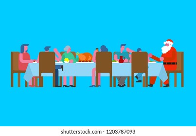 Family Christmas dinner and Santa. Big table. Red caps. holiday lunch new year. Father and mother. Grandmother and grandfather. Relatives feast
