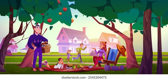 Family enjoying outdoor picnic beneath apple trees in suburban park. Parents with three children spread blanket near houses. Father holds wicker basket, mother rests in chair, kids playing around.