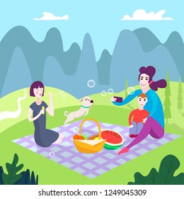 The family enjoys a picnic. My daughter is blowing bubbles, the dog is running after soap bubbles, mother and son are taking selfies. On the background of a natural park, mountains, forests. 