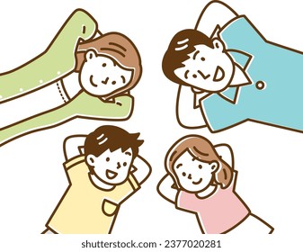 A family of four smiling and lying on their backs